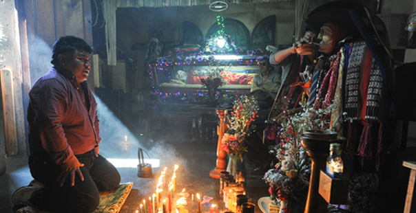 Santiago de Atitlan, Guatemala - February 11, 2014: Maya shaman with the divinity of Maximon at Santiago de Atitlan on Guatemala