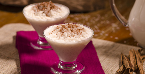 Two glasses of rice pudding,arroz con leche over a fuchsia napkin.